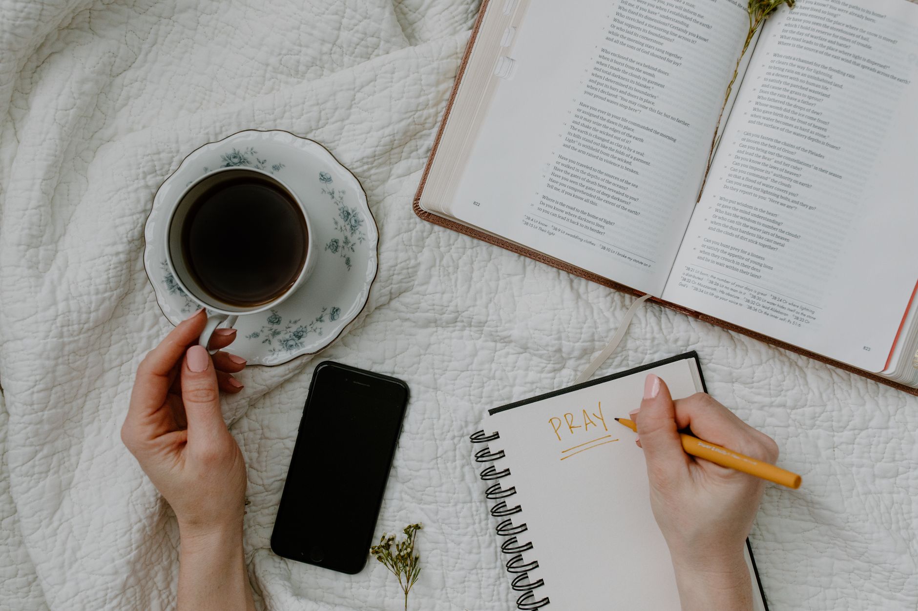A serene morning meditation scene with coffee, Bible, and journal.